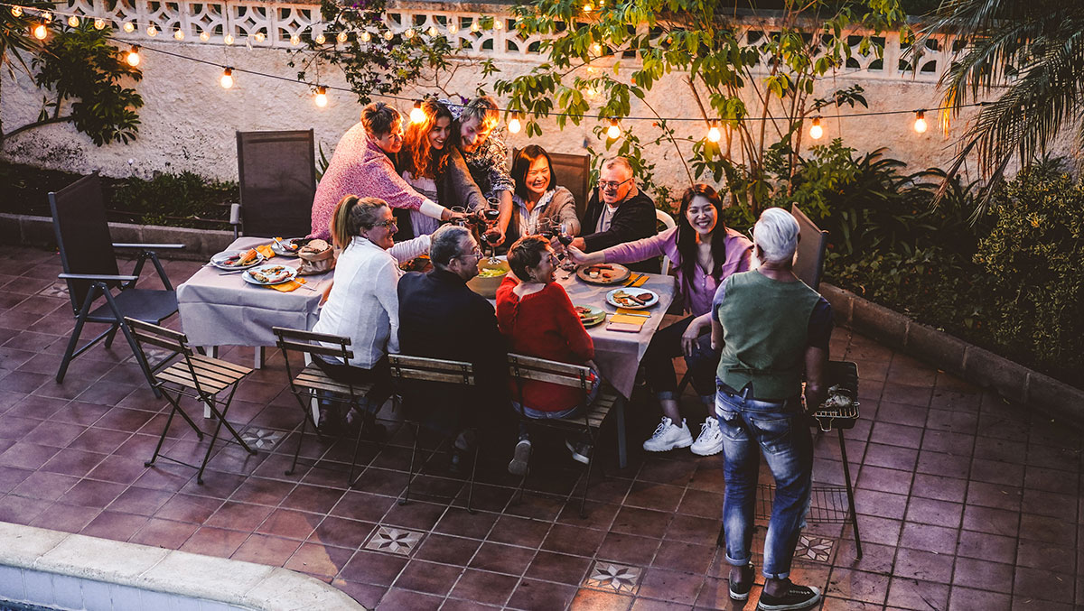 family gathered for a meal to represent financial tips for traveling