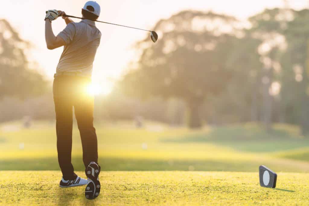 man-swinging-golf-club