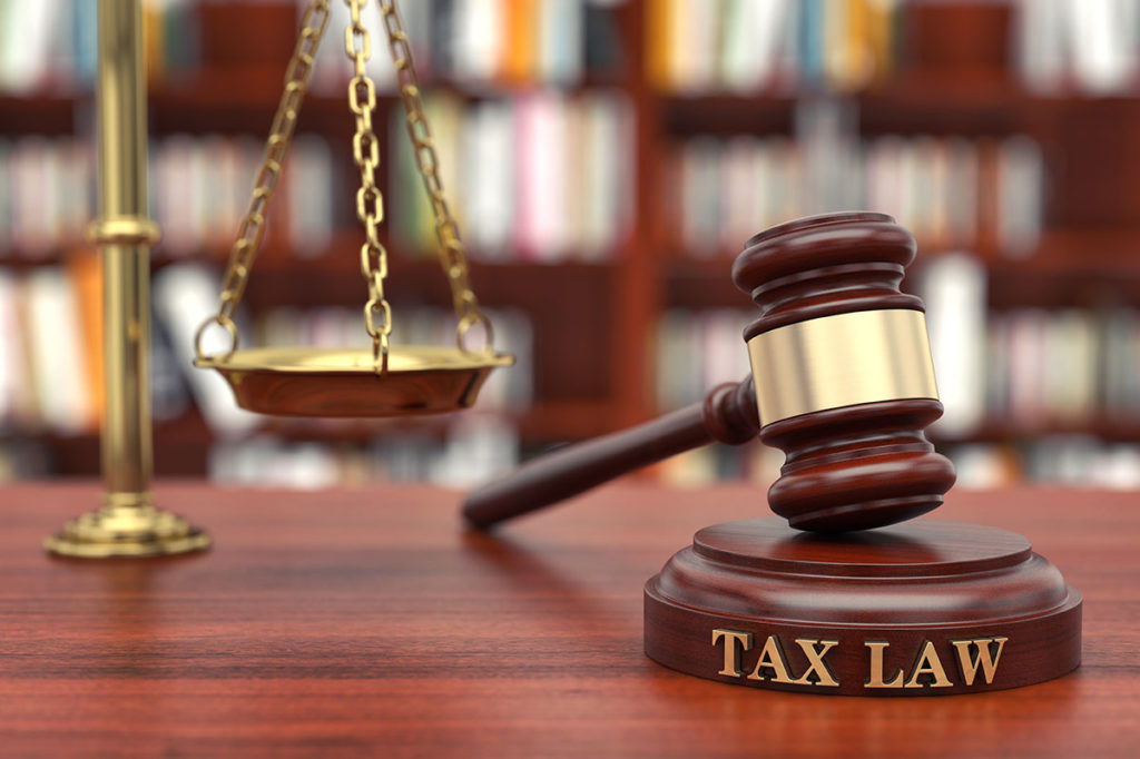 judge's gavel resting on a block that says "tax law"